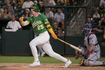 Aug 29, 2025; West Sacramento, California, USA; Athletics outfielder Brent Rooker (25) hits an rbi double against the Texas Rangers during the third inning at Sutter Health Park. Mandatory Credit: Ed Szczepanski-Imagn Images