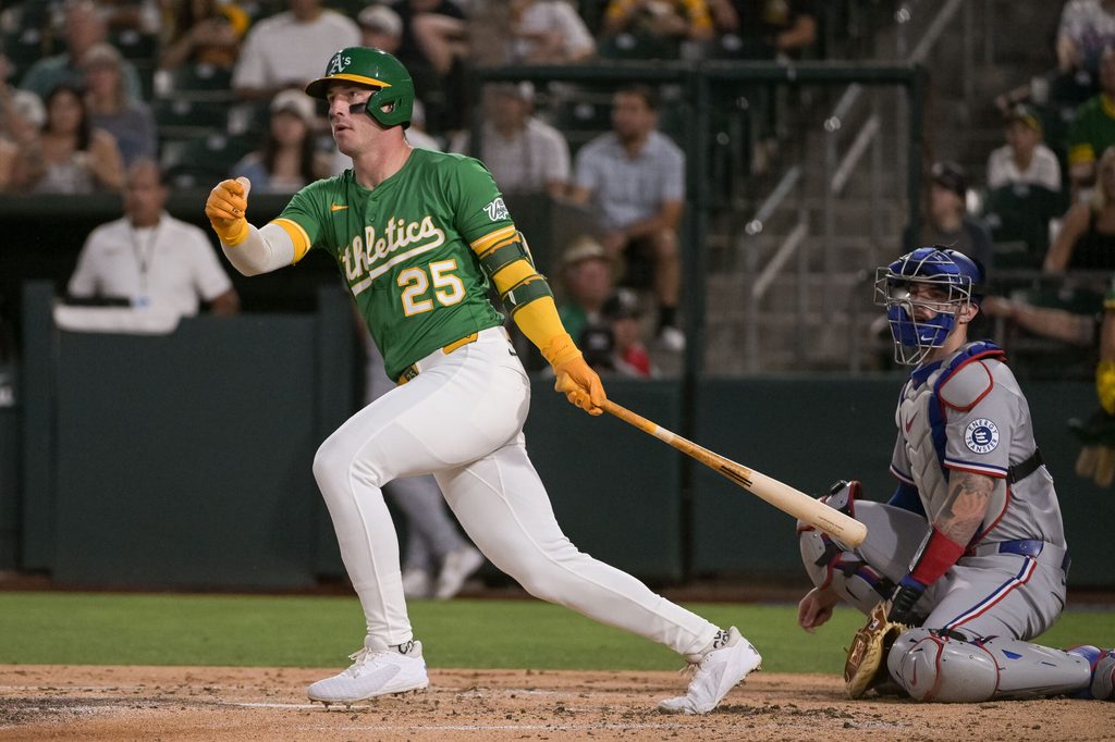 Aug 29, 2025; West Sacramento, California, USA; Athletics outfielder Brent Rooker (25) hits an rbi double against the Texas Rangers during the third inning at Sutter Health Park. Mandatory Credit: Ed Szczepanski-Imagn Images