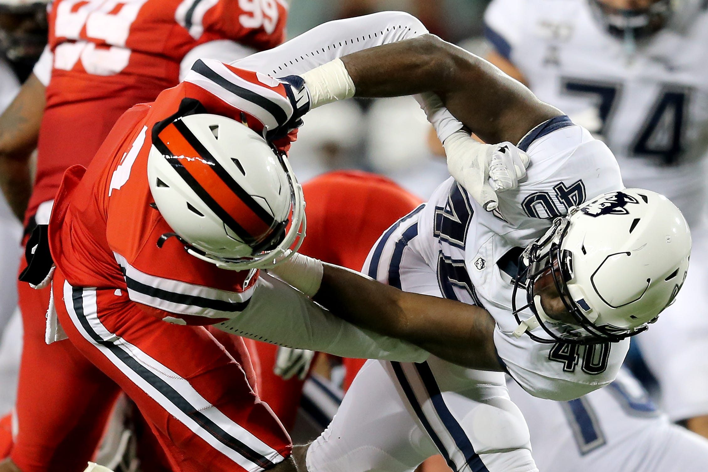 Cincinnati Bearcats cornerback Arquon Bush (9) and Connecticut Huskies tight end Jayce Medlock (40) entangle  in the fourth quarter of a college football game, Saturday, Nov. 9, 2019, at Nippert Stadium in Cincinnati.

Connecticut Huskies At Cincinnati Bearcats Nov 9