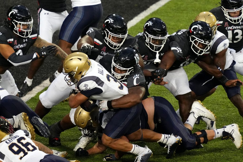Navy Midshipmen fullback Anton Hall Jr. (34) carries the ball as Cincinnati Bearcats defensive lineman Jowon Briggs (18) makes the tackle near the goal line in the third quarter during a college football game, Saturday, Nov. 5, 2022, at Nippert Stadium in Cincinnati. The Cincinnati Bearcats won, 20-10.
Ncaaf Navy Midshipmen At Cincinnati Bearcats Nov 6 0672