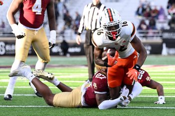 Nov 24, 2023; Chestnut Hill, Massachusetts, USA; Boston College Eagles linebacker Daveon Crouch (27) tackles Miami Hurricanes wide receiver Isaiah Horton (16) during the second half at Alumni Stadium. Mandatory Credit: Brian Fluharty-Imagn Images