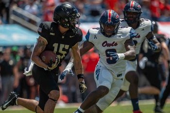 Army Black Knights running back Noah Short #15 carries the ball as Florida Atlantic University Owls linebacker Desmond Tisdol #9 looks to tackle during college football action as the Florida Atlantic University Owls host Army's Black Knights on September 7, 2024, in Boca Raton, Fla. Army led 14-7 at halftime.