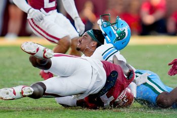 Tulane Green Wave quarterback Darian Mensah (10) loses his helmet as Oklahoma Sooners defensive back Robert Spears-Jennings (3) brings him down during a college football game between the University of Oklahoma Sooners (OU) and the Tulane Green Wave at Gaylord Family - Oklahoma Memorial Stadium in Norman, Okla., Saturday, Sept. 14, 2024.