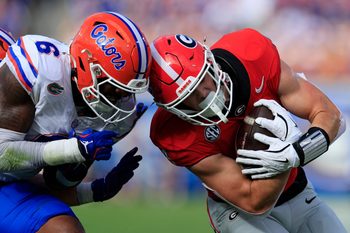 Florida Gators linebacker Shemar James (6) tackles Georgia Bulldogs tight end Oscar Delp (4) during the first quarter of an NCAA college football matchup Saturday, Nov. 2, 2024 at EverBank Stadium in Jacksonville, Fla. The Georgia Bulldogs defeated the Florida Gators 34-20. [Corey Perrine/Florida Times-Union]