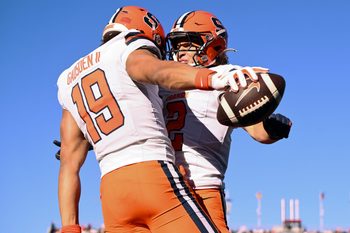 Nov 9, 2024; Chestnut Hill, Massachusetts, USA; Syracuse Orange tight end Oronde Gadsden II (19) celebrates with wide receiver Trebor Pena (2) after scoring a touchdown against the Boston College Eagles during the first half at Alumni Stadium. Mandatory Credit: Brian Fluharty-Imagn Images