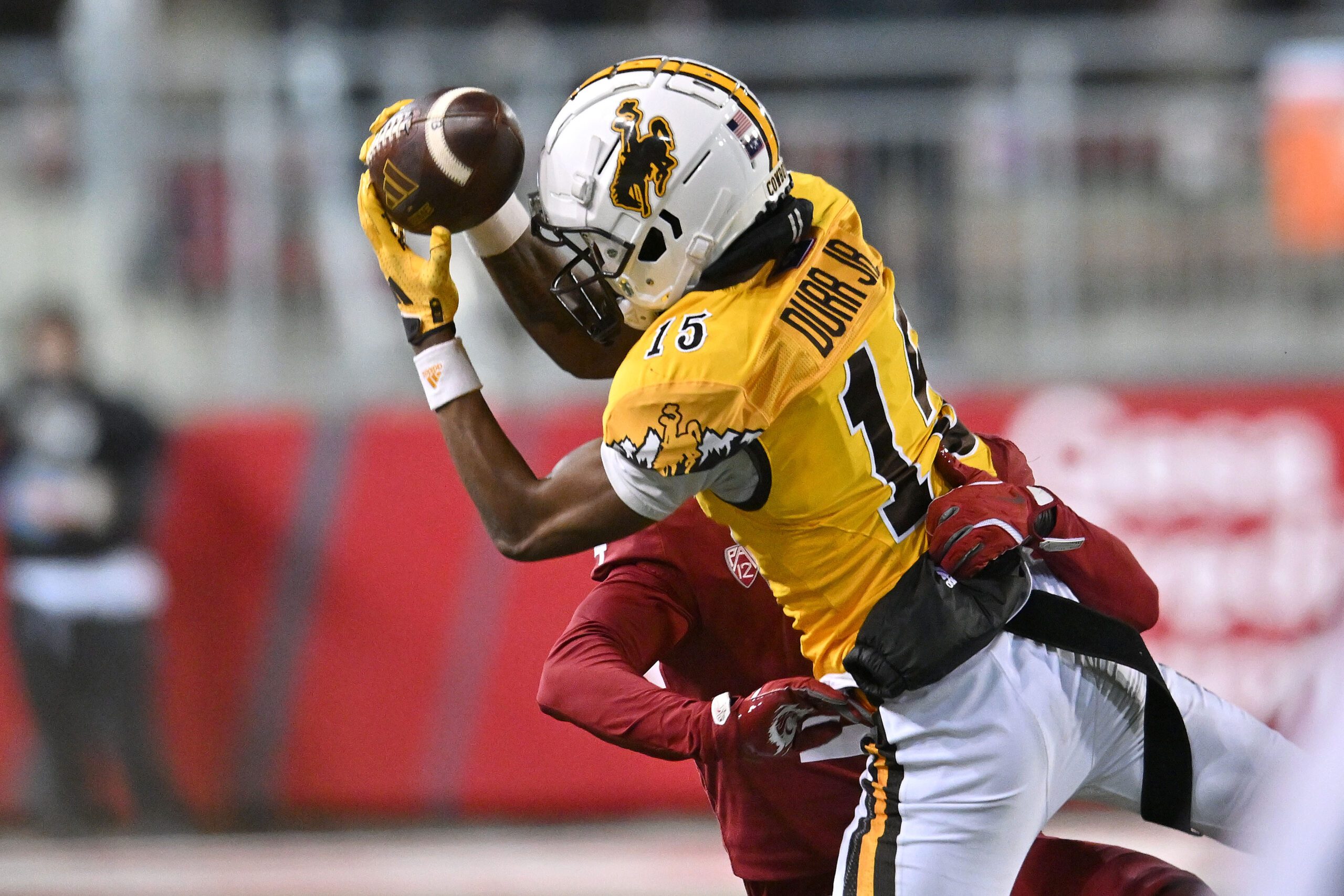 Nov 30, 2024; Pullman, Washington, USA; Wyoming Cowboys wide receiver Chris Durr Jr. (15) makes a sideline catch against Washington State Cougars defensive back Kapena Gushiken (4) in the second half at Gesa Field at Martin Stadium. Washington State Cougars won 15-14. Mandatory Credit: James Snook-Imagn Images