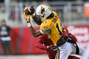 Nov 30, 2024; Pullman, Washington, USA; Wyoming Cowboys wide receiver Chris Durr Jr. (15) makes a sideline catch against Washington State Cougars defensive back Kapena Gushiken (4) in the second half at Gesa Field at Martin Stadium. Washington State Cougars won 15-14. Mandatory Credit: James Snook-Imagn Images