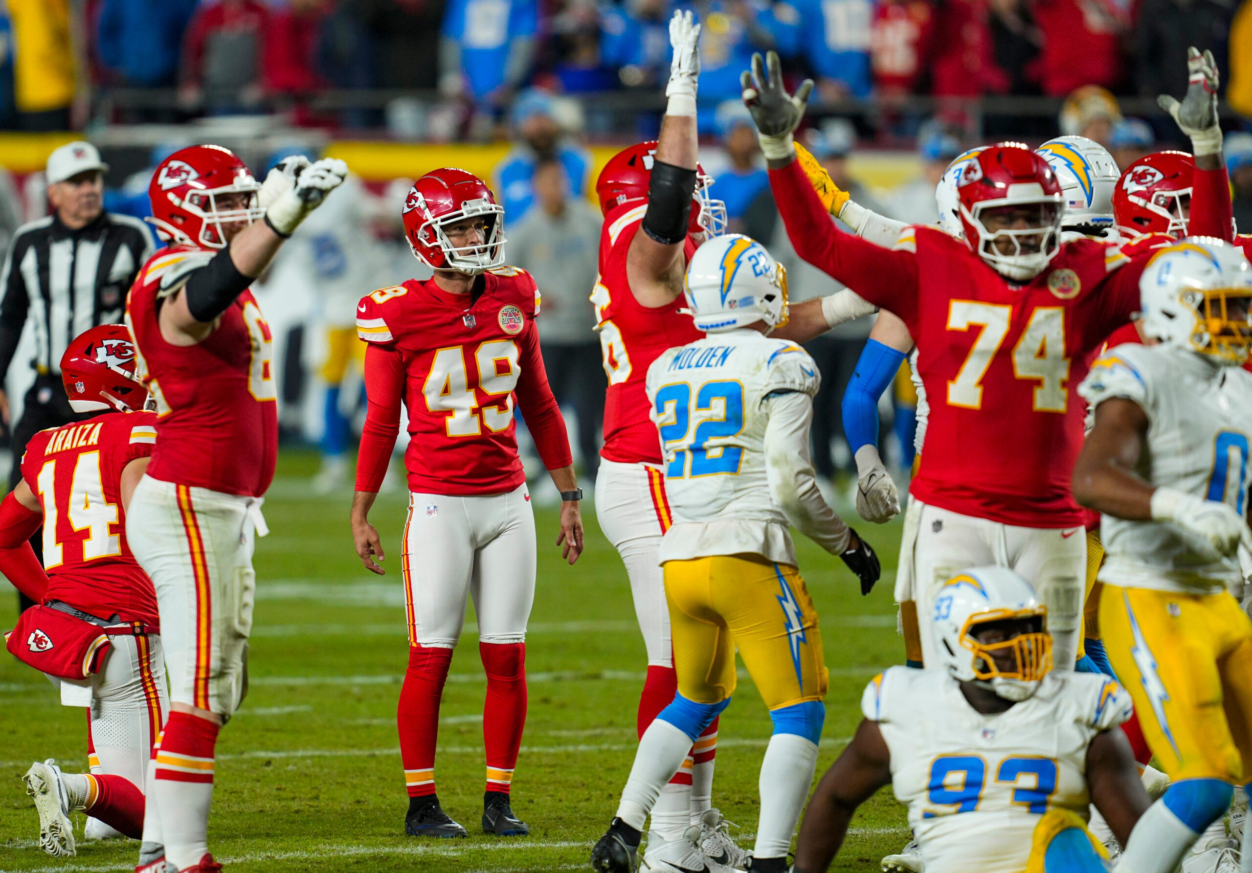 Dec 8, 2024; Kansas City, Missouri, USA; Kansas City Chiefs place kicker Matthew Wright (49) watches a game winning field goal as time expires against the Los Angeles Chargers at GEHA Field at Arrowhead Stadium. Mandatory Credit: Jay Biggerstaff-Imagn Images