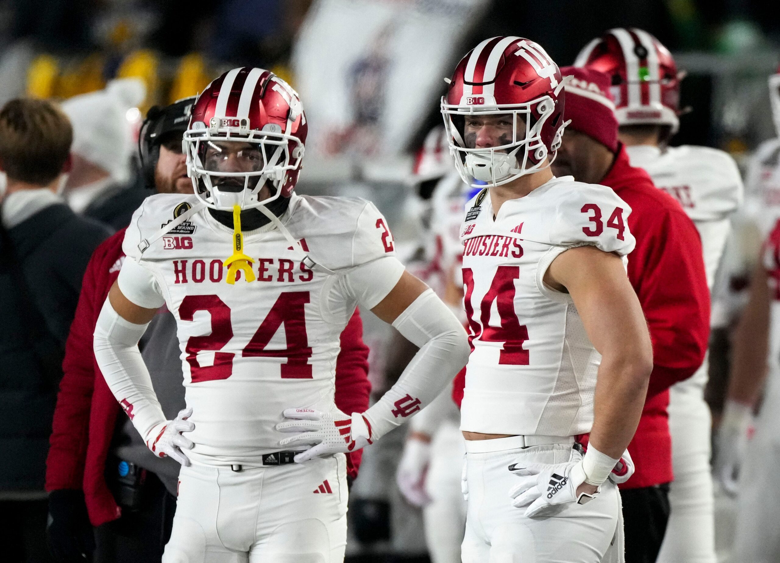 Indiana Hoosiers defensive back Bryson Bonds (24) and Indiana Hoosiers linebacker Jeff Utzinger (34) watch the second half of a game between the Indiana Hoosiers and the Notre Dame Fighting Irish in first round of the College Football Playoff on Saturday, Dec. 21, 2024, in South Bend. Notre Dame defeated Indiana 27-17.