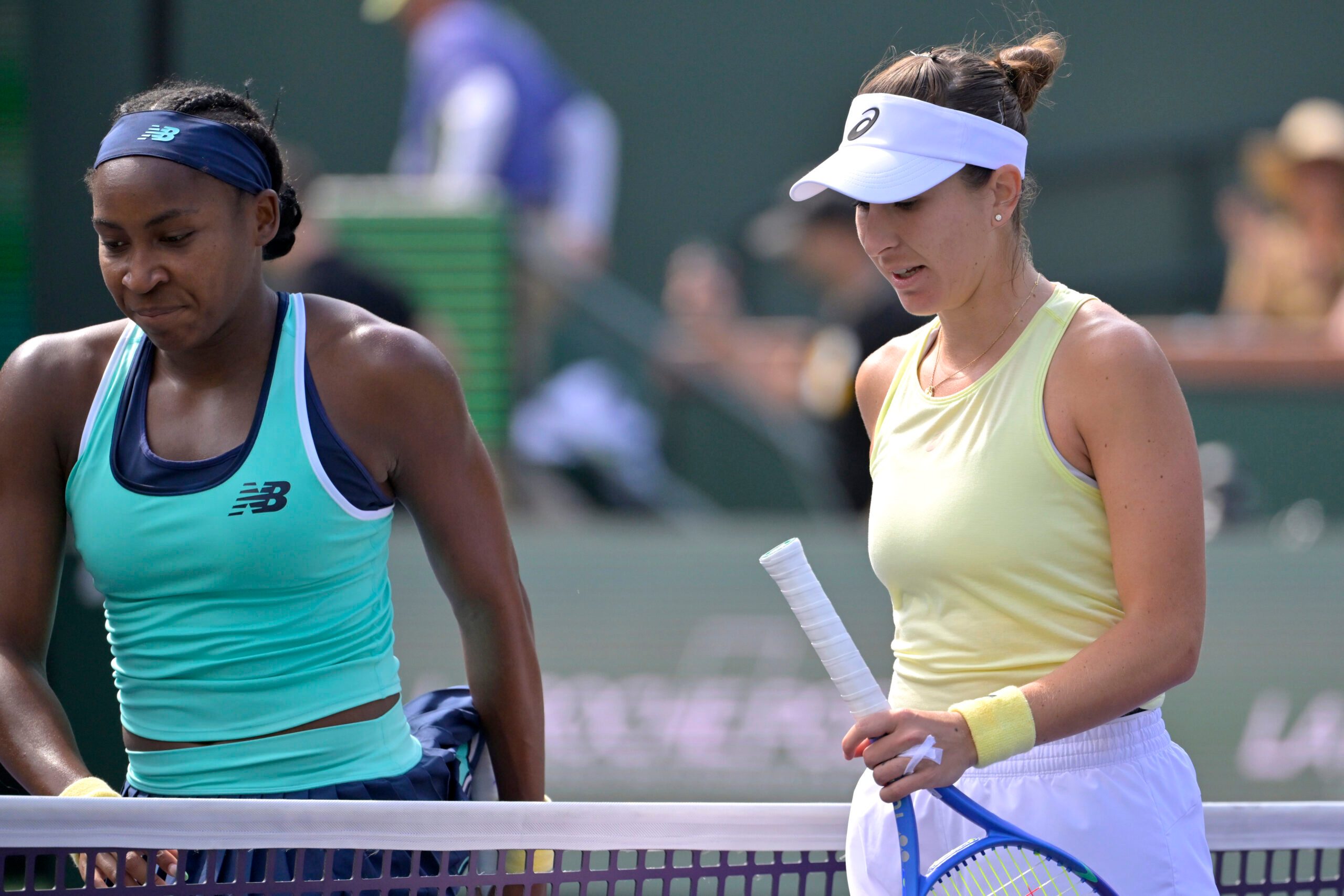 Mar 12, 2025; Indian Wells, CA, USA;  Coco Gauff (USA) and Belinda Bencic (SUI) leave the court following the fourth round of the BNP Paribas Open at the Indian Well Tennis Garden. Mandatory Credit: Jayne Kamin-Oncea-Imagn Images