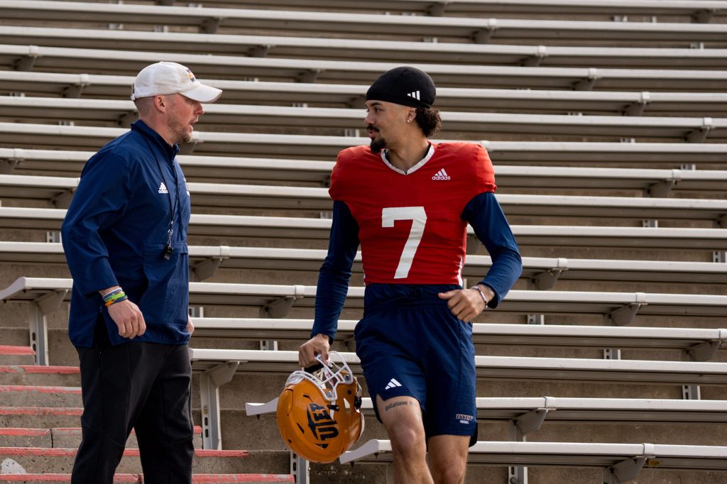 UTEP sophomore quarterback Malachi Nelson (7) and head coach Scotty Walden talk as they walk down from the Mine Shaft to the field for spring practice at the Sun Bowl in El Paso, Texas, on Friday, April 4, 2025.