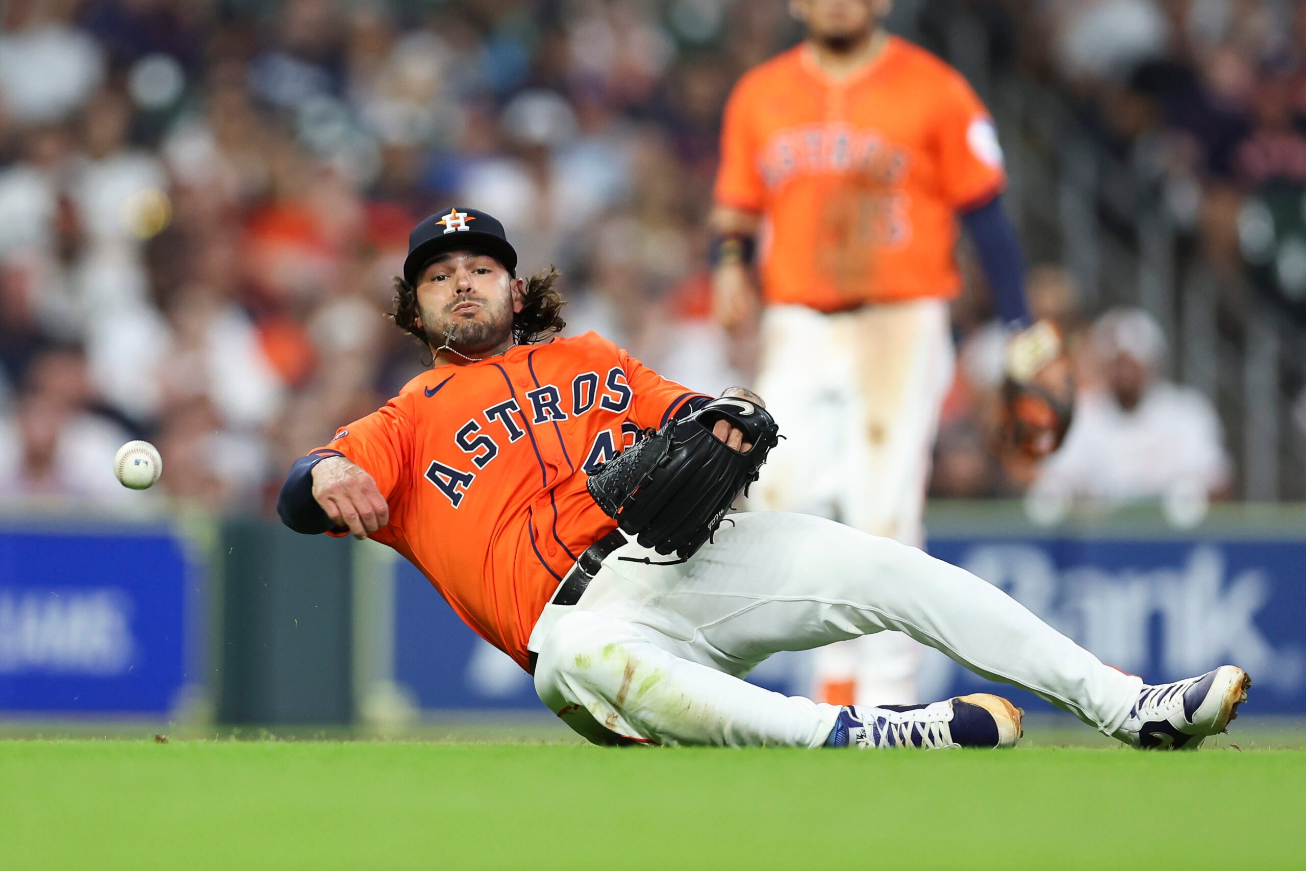 Jul 11, 2025; Houston, Texas, USA; Houston Astros starting pitcher Lance McCullers Jr. (43) throws from the ground but is unable to get an out on an infield single by Texas Rangers first baseman Jake Burger (not pictured) during the third inning at Daikin Park. Mandatory Credit: Troy Taormina-Imagn Images