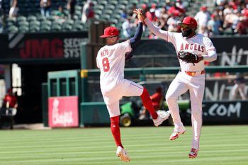 Jul 27, 2025; Anaheim, California, USA;  Los Angeles Angels shortstop Zach Neto (9) and center fielder Jo Adell (7) celebrate a win after defeating the Seattle Mariners 4-1 at Angel Stadium. Mandatory Credit: Kiyoshi Mio-Imagn Images
