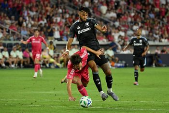 Jul 30, 2025; St. Louis, Missouri, USA; St. Louis City forward Simon Becher (11) falls to the pitch while battling Aston Villa defender Tyrone Mings (5) for the ball in the second half at Energizer Park. Mandatory Credit: Joe Puetz-Imagn Images