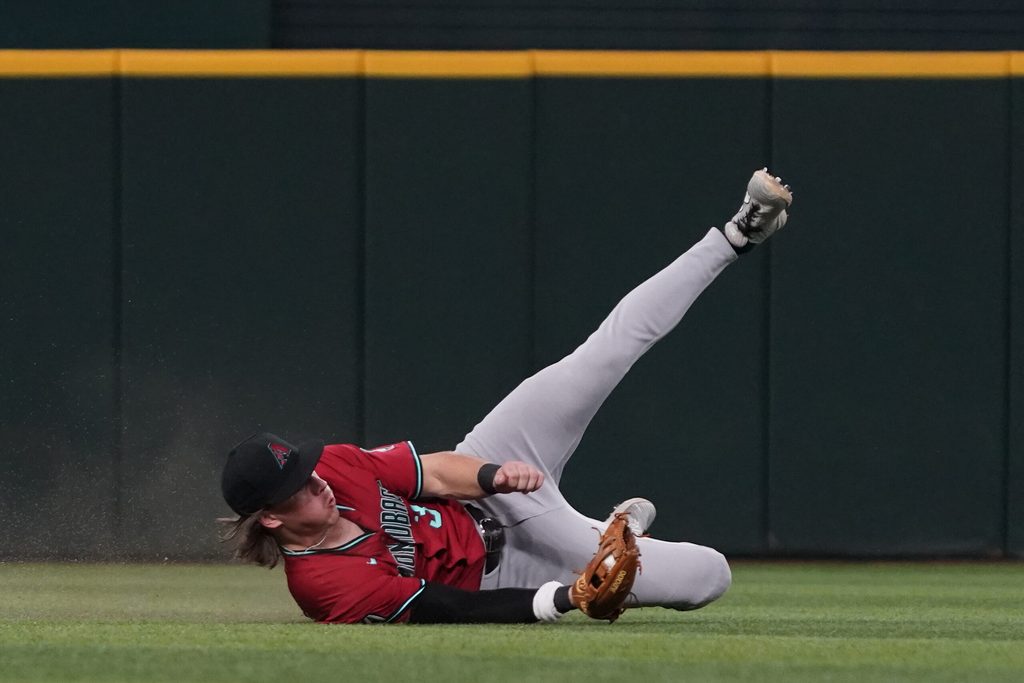 Aug 13, 2025; Arlington, Texas, USA; Arizona Diamondbacks center fielder Jake McCarthy (31) makes a sliding catch during the ninth inning against the Texas Rangers at Globe Life Field. Mandatory Credit: Raymond Carlin III-Imagn Images