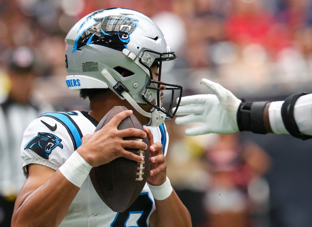 Aug 16, 2025; Houston, Texas, USA; Carolina Panthers quarterback Bryce Young (9) tries to avoid the grip of Houston Texans defensive end Will Anderson Jr. (51) in the first quarter at NRG Stadium. Mandatory Credit: Thomas Shea-Imagn Images