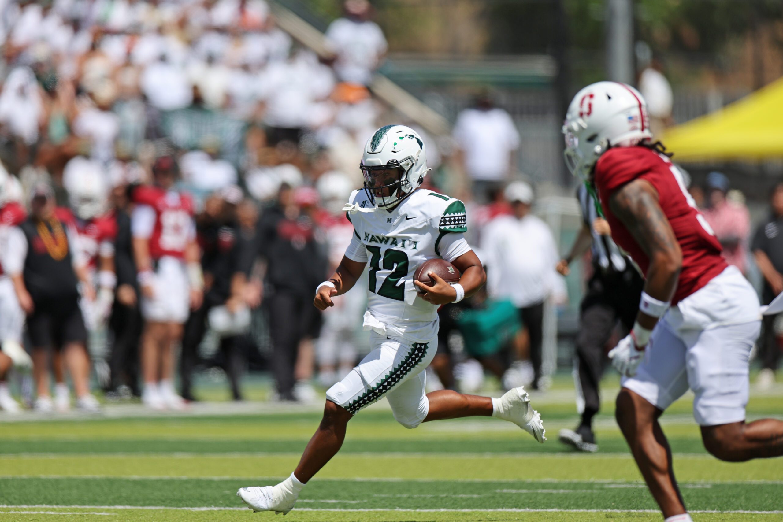 Aug 23, 2025; Honolulu, Hawaii, USA; Hawaii Rainbow Warriors quarterback Micah Alejado (12) runs through the Stanford Cardinal defense during the first half of an NCAA college football game at Clarence T.C. Ching Athletics Complex. Mandatory Credit: Marco Garcia-Imagn Images