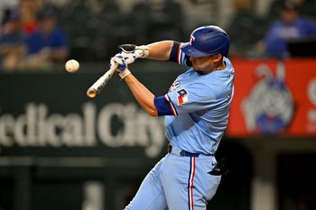Aug 24, 2025; Arlington, Texas, USA; Texas Rangers shortstop Corey Seager (5) hits a single against the Cleveland Guardians during the eighth inning at Globe Life Field. Mandatory Credit: Jerome Miron-Imagn Images