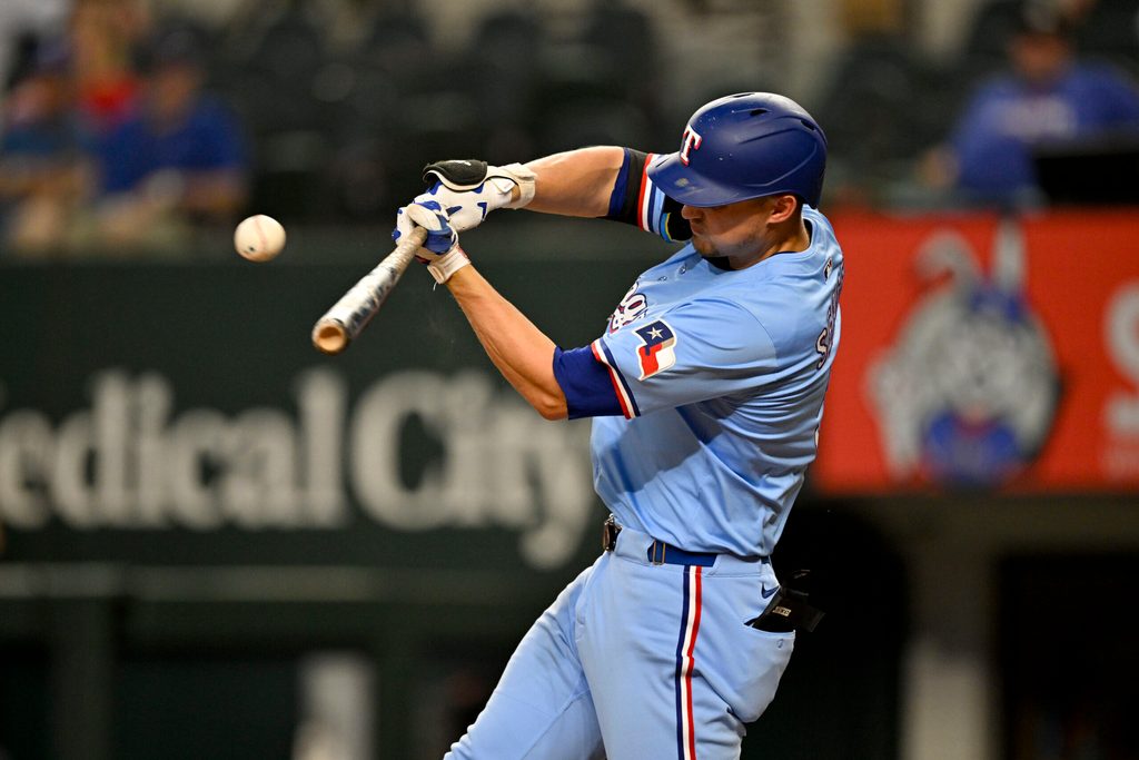 Aug 24, 2025; Arlington, Texas, USA; Texas Rangers shortstop Corey Seager (5) hits a single against the Cleveland Guardians during the eighth inning at Globe Life Field. Mandatory Credit: Jerome Miron-Imagn Images