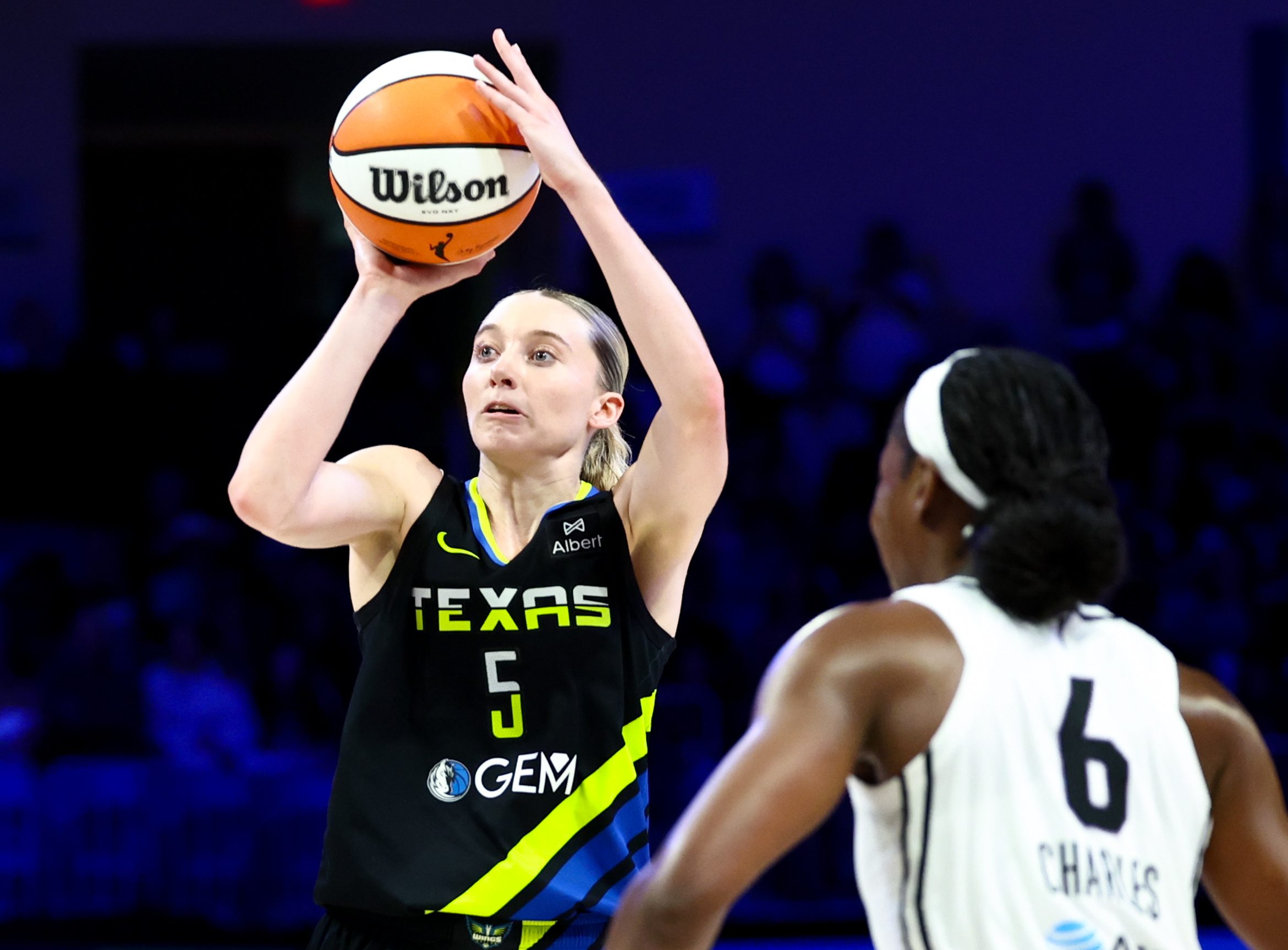 Aug 24, 2025; Arlington, Texas, USA;  Dallas Wings guard Paige Bueckers (5) shoots over Golden State Valkyries guard Kaila Charles (6) during the second half at College Park Center. Mandatory Credit: Kevin Jairaj-Imagn Images
