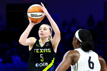 Aug 24, 2025; Arlington, Texas, USA;  Dallas Wings guard Paige Bueckers (5) shoots over Golden State Valkyries guard Kaila Charles (6) during the second half at College Park Center. Mandatory Credit: Kevin Jairaj-Imagn Images