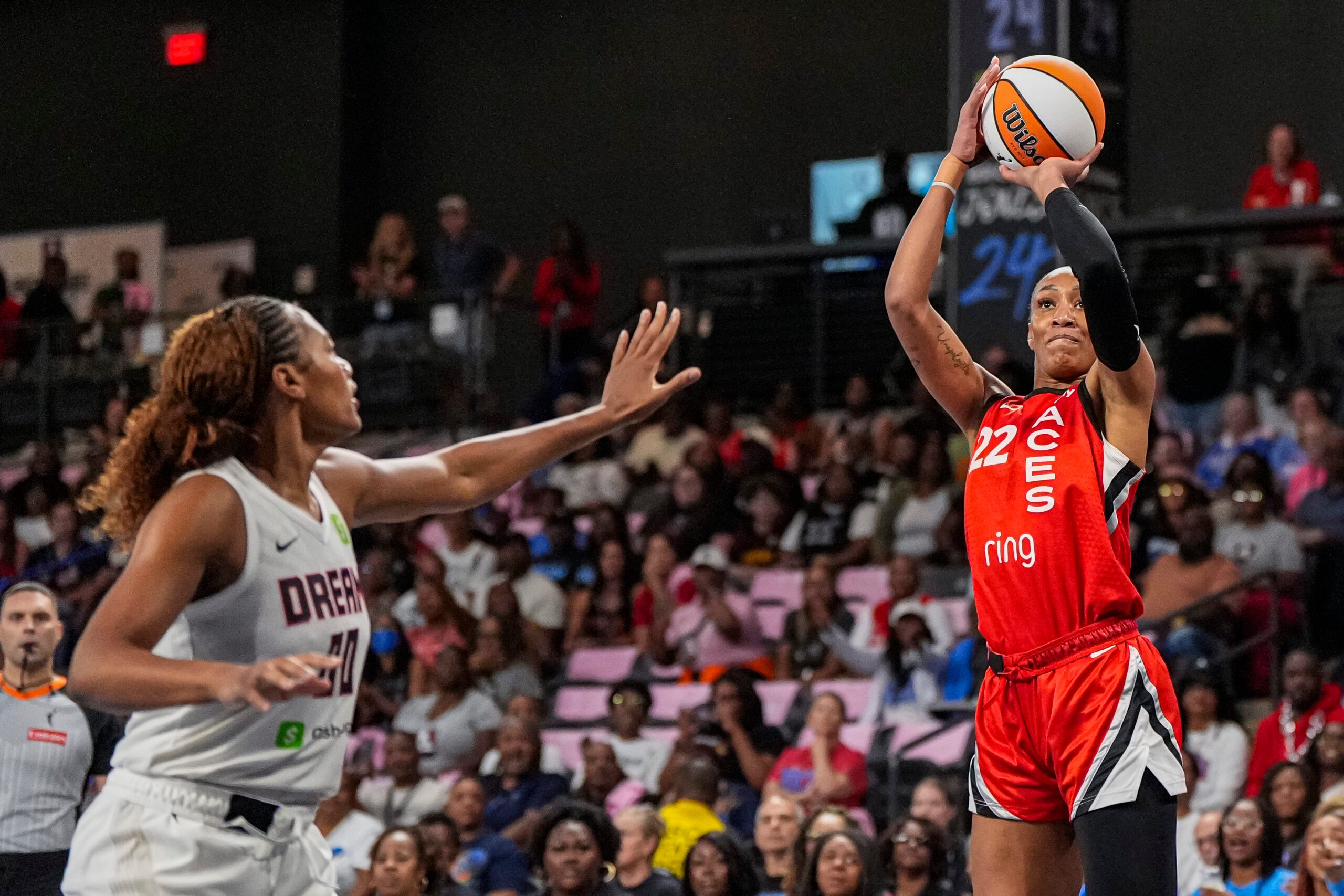 Aug 27, 2025; College Park, Georgia, USA; Las Vegas Aces center A'ja Wilson (22) shoots over Atlanta Dream forward Naz Hillmon (00) during the first half at Gateway Center Arena at College Park. Mandatory Credit: Dale Zanine-Imagn Images