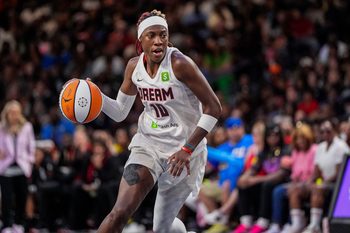 Aug 27, 2025; College Park, Georgia, USA; Atlanta Dream guard Rhyne Howard (10) controls the ball against the Las Vegas Aces during the second half at Gateway Center Arena at College Park. Mandatory Credit: Dale Zanine-Imagn Images