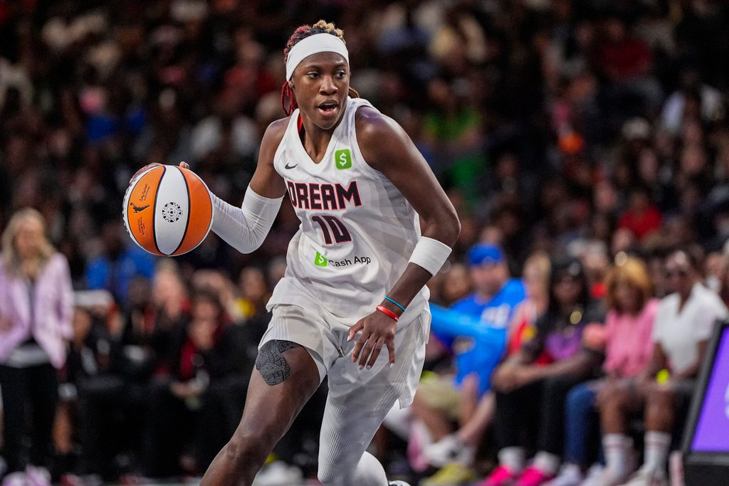 Aug 27, 2025; College Park, Georgia, USA; Atlanta Dream guard Rhyne Howard (10) controls the ball against the Las Vegas Aces during the second half at Gateway Center Arena at College Park. Mandatory Credit: Dale Zanine-Imagn Images