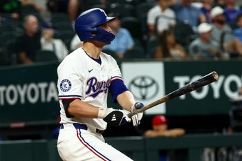 Aug 27, 2025; Arlington, Texas, USA;  Texas Rangers shortstop Corey Seager (5) hits a two-run home run during the fourth inning against the Los Angeles Angels at Globe Life Field. Mandatory Credit: Kevin Jairaj-Imagn Images