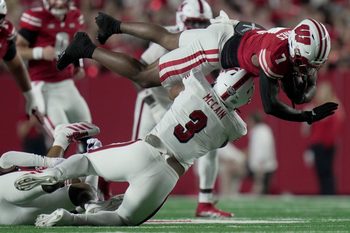Wisconsin running back Dilin Jones (7) is tackled by Miami (Ohio) linebacker Malcolm McCain (3) after picking a first down during the first quarter of their game Thursday, August 28, 2025 at Camp Randall Stadium in Madison, Wisconsin.