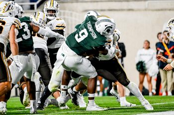 Michigan State's Jalen Thompson, left, tackles Western Michigan's Jalen Buckley for a safety during the third quarter on Friday, Aug. 29, 2025, in East Lansing.