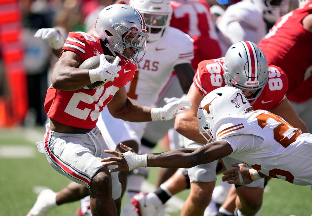 Ohio State Buckeyes running back James Peoples (20) makes Texas Longhorns linebacker Ty'Anthony Smith (26) miss while running the ball in the fourth quarter of their game at Ohio Stadium in Columbus, Ohio on Aug 30, 2025.
