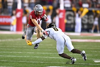 Aug 30, 2025; Pullman, Washington, USA; Washington State Cougars running back Kirby Vorhees (9) tries to jump pass Idaho Vandals defensive back Jhamell Blenman (0) in the second half at Gesa Field at Martin Stadium. Washington State Cougars won 13-10. Mandatory Credit: James Snook-Imagn Images