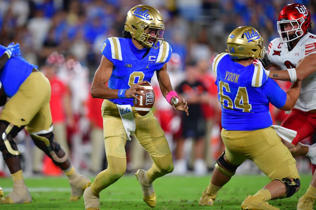 Aug 30, 2025; Pasadena, California, USA; UCLA Bruins quarterback Nico Iamaleava (9) moves out to pass as offensive lineman Sam Yoon (64) provides coverage against Utah Utes linebacker Lander Barton (8) during the second half at Rose Bowl. Mandatory Credit: Gary A. Vasquez-Imagn Images