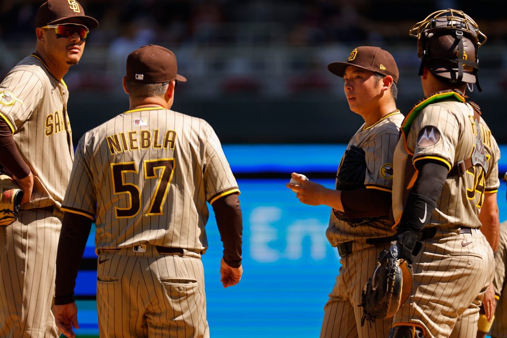 Aug 31, 2025; Minneapolis, Minnesota, USA; San Diego Padres relief pitcher Yuki Matsui (1) awaits pitching coach Ruben Niebla in the seventh inning of the game with the Minnesota Twins at Target Field. Mandatory Credit: Bruce Kluckhohn-Imagn Images