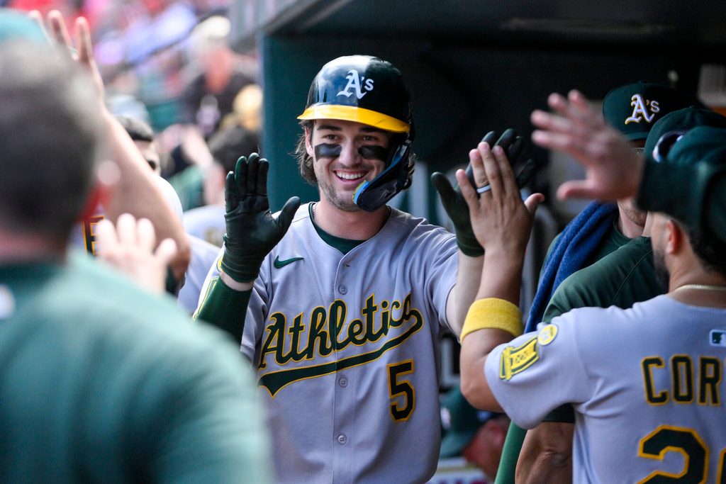Sep 1, 2025; St. Louis, Missouri, USA; Athletics shortstop Jacob Wilson (5) is congratulated by teammates after scoring against the St. Louis Cardinals during the seventh inning at Busch Stadium. Mandatory Credit: Jeff Curry-Imagn Images