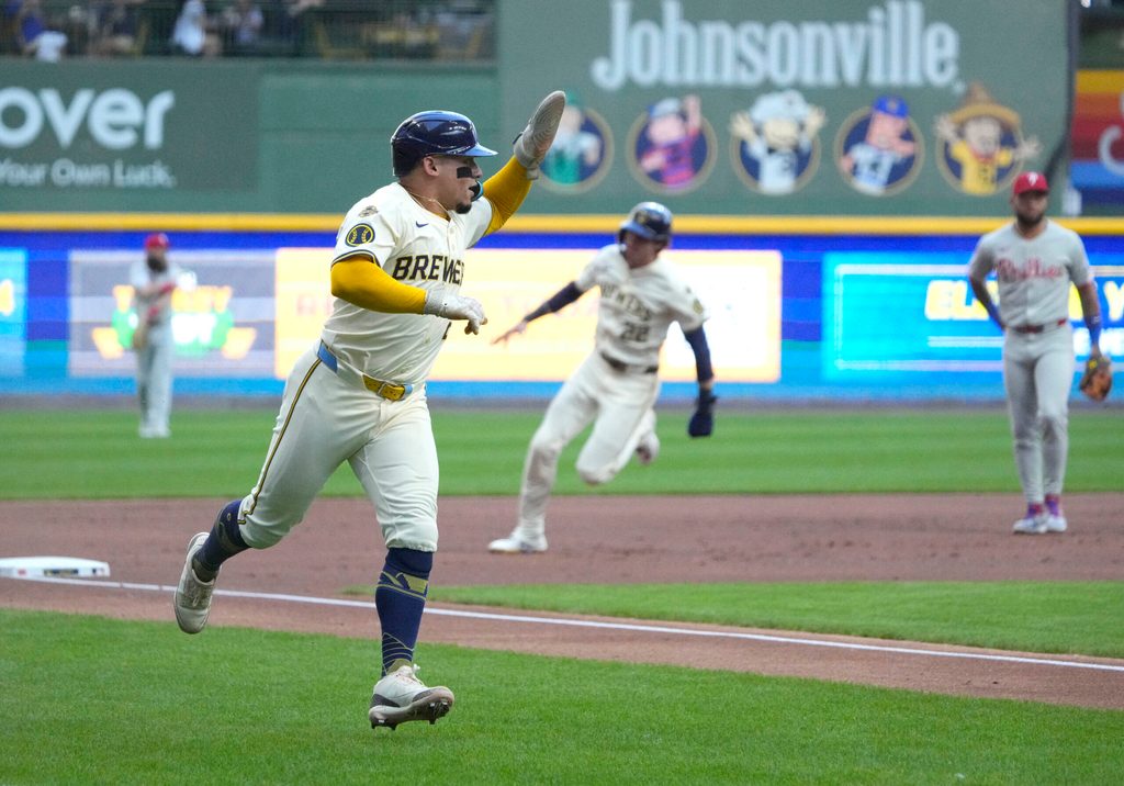 Sep 1, 2025; Milwaukee, Wisconsin, USA; Milwaukee Brewers catcher William Contreras (24) rounds third base with outfielder Christian Yelich (22) right behind him against the Philadelphia Phillies in the first inning at American Family Field. Mandatory Credit: Michael McLoone-Imagn Images