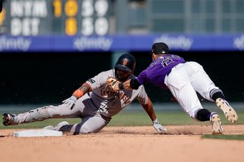 Sep 1, 2025; Denver, Colorado, USA; San Francisco Giants first baseman Dominic Smith (7) is tagged out attempting to advance to second against Colorado Rockies outfielder Tyler Freeman (2) in the fifth inning at Coors Field. Mandatory Credit: Isaiah J. Downing-Imagn Images