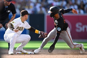 Sep 1, 2025; San Diego, California, USA; Baltimore Orioles second baseman Jeremiah Jackson (82) is tagged out by San Diego Padres second baseman Jose Iglesias (7) as he tries to steal second base during the third inning at Petco Park. Mandatory Credit: Denis Poroy-Imagn Images