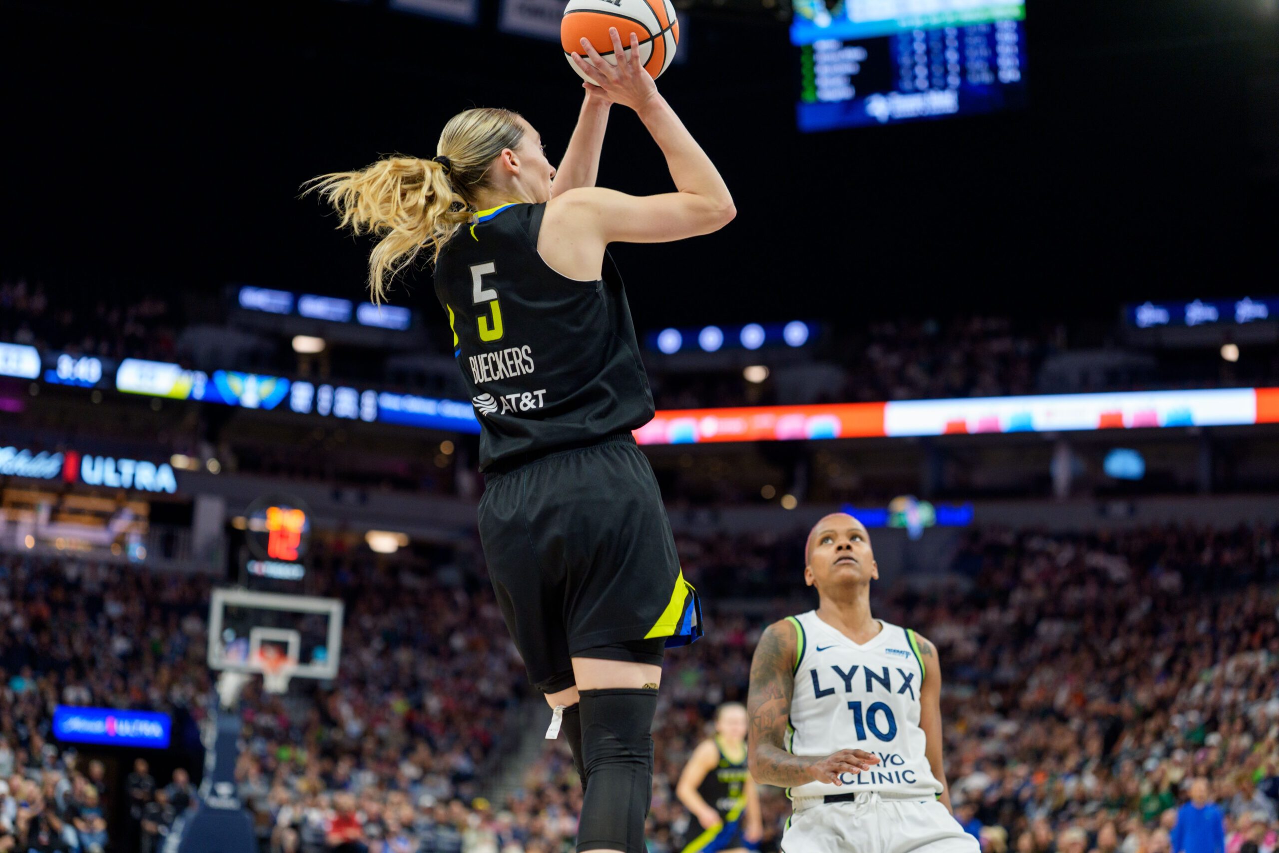 Sep 1, 2025; Minneapolis, Minnesota, USA; Dallas Wings guard Paige Bueckers (5) shoots over Minnesota Lynx guard Courtney Williams (10) in the third quarter at Target Center. Mandatory Credit: Matt Blewett-Imagn Images