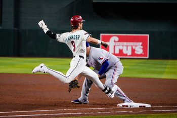 Sep 2, 2025; Phoenix, Arizona, USA; Arizona Diamondbacks shortstop Blaze Alexander (9) gets safely on base in the fourth inning of the game between Arizona Diamondbacks and Texas Rangers at Chase Field. Mandatory Credit: Arianna Grainey-Imagn Images