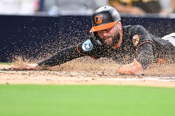 Sep 2, 2025; San Diego, California, USA; Baltimore Orioles left fielder Colton Cowser (17) slides as he scores during the third inning against the San Diego Padres at Petco Park. Mandatory Credit: Denis Poroy-Imagn Images