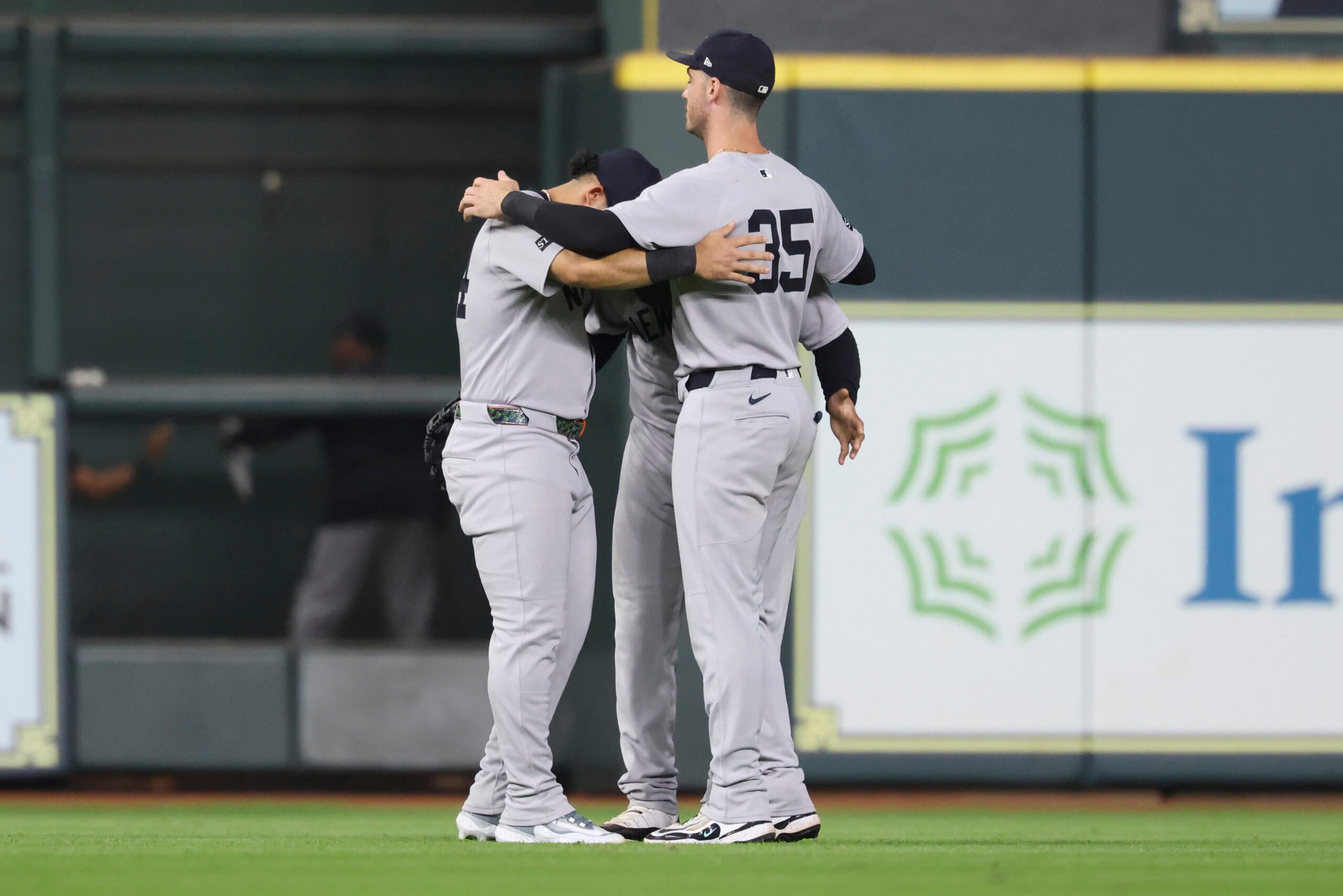 Sep 2, 2025; Houston, Texas, USA; New York Yankees left fielder Jasson Dominguez (24) and center fielder Trent Grisham (12) and right fielder Cody Bellinger (35) celebrate after the game against the Houston Astros at Daikin Park. Mandatory Credit: Troy Taormina-Imagn Images