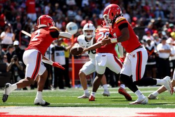 Aug 30, 2025; College Park, Maryland, USA; Maryland Terrapins quarterback Malik Washington (7) hands the ball off to Maryland Terrapins running back Nolan Ray (2) during the second half against the Florida Atlantic Owls at SECU Stadium. Mandatory Credit: Daniel Kucin Jr.-Imagn Images