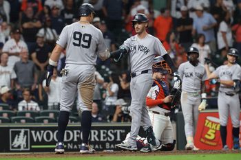 Sep 3, 2025; Houston, Texas, USA; New York Yankees right fielder Cody Bellinger (35) celebrates with designated hitter Aaron Judge (99) after hitting a three-run home run during the ninth inning against the Houston Astros at Daikin Park. Mandatory Credit: Troy Taormina-Imagn Images
