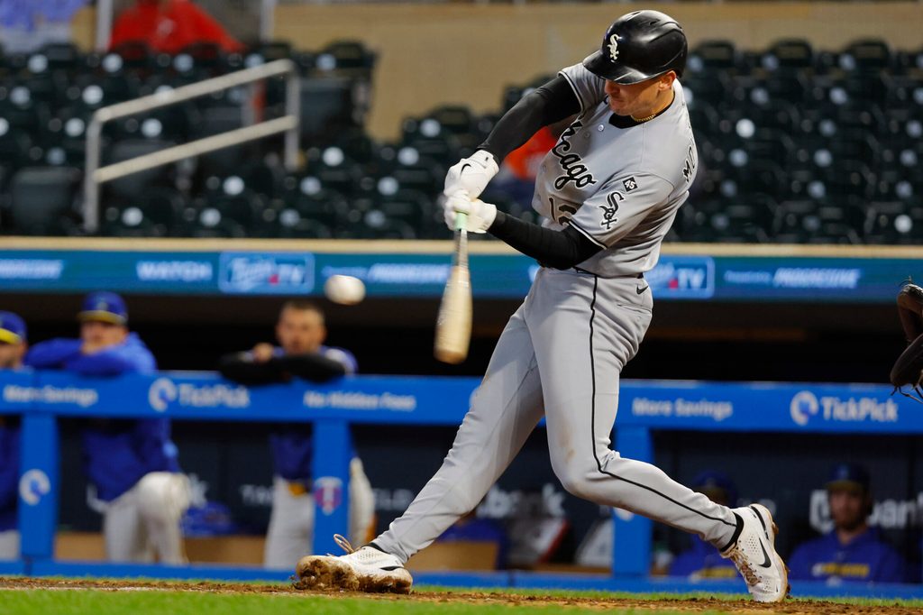 Sep 4, 2025; Minneapolis, Minnesota, USA; Chicago White Sox shortstop Colson Montgomery (12) hits a two-run home run against the Minnesota Twins in the ninth inning at Target Field. Mandatory Credit: Bruce Kluckhohn-Imagn Images