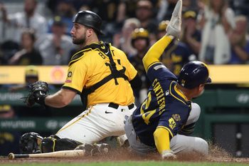 Sep 5, 2025; Pittsburgh, Pennsylvania, USA;  Milwaukee Brewers catcher William Contreras (24) slides behind Pittsburgh Pirates catcher Joey Bart (14) to score a run during the ninth inning at PNC Park. Mandatory Credit: Charles LeClaire-Imagn Images