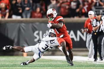 Louisville Cardinals running back Isaac Brown (1) breaks away from James Madison Dukes defensive back DJ Barksdale (32) to score a big fourth quarter touchdown against James Madison during the Cards' second college football game Friday September 5, 2025 at L&N Credit Union Stadium in Louisville, Kentucky. The Cards beat the Dukes 28-14.