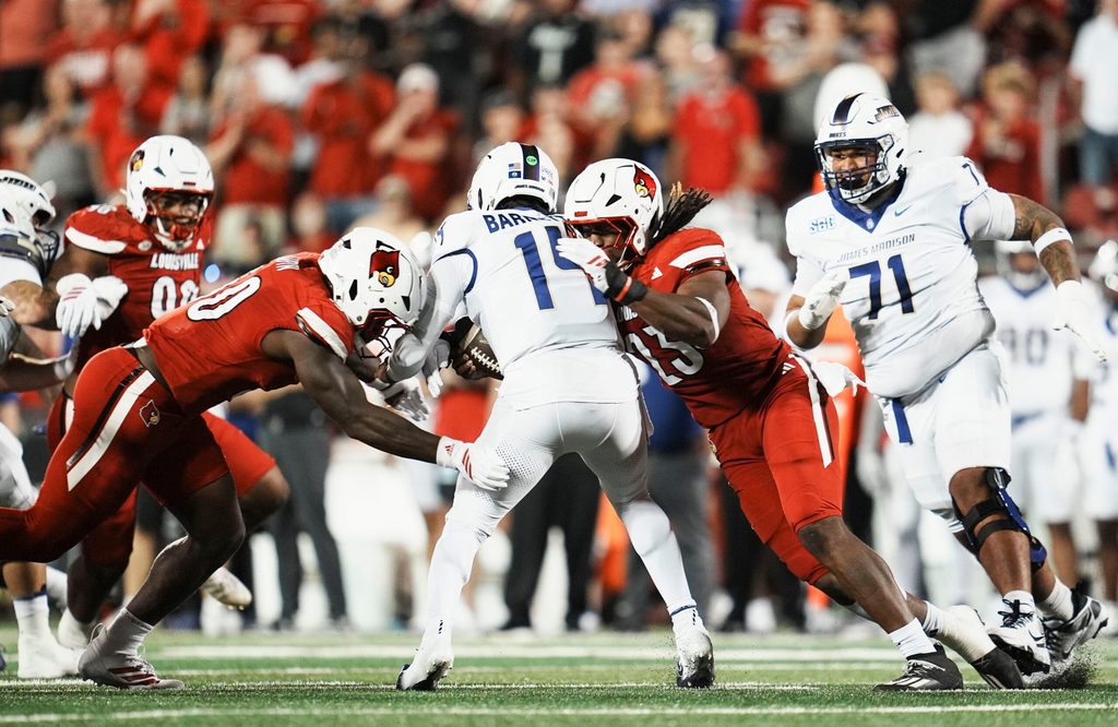 Louisville Cardinals defensive lineman Clev Lubin (50) and Louisville Cardinals defensive lineman Wesley Bailey (23) sack DUPLICATE***James Madison Dukes quarterback Alonza Barnett III (14) in the first half during the Louisville-James Madison college football game Friday September 5, 2025 at L&N Credit Union Stadium in Louisville, Kentucky.