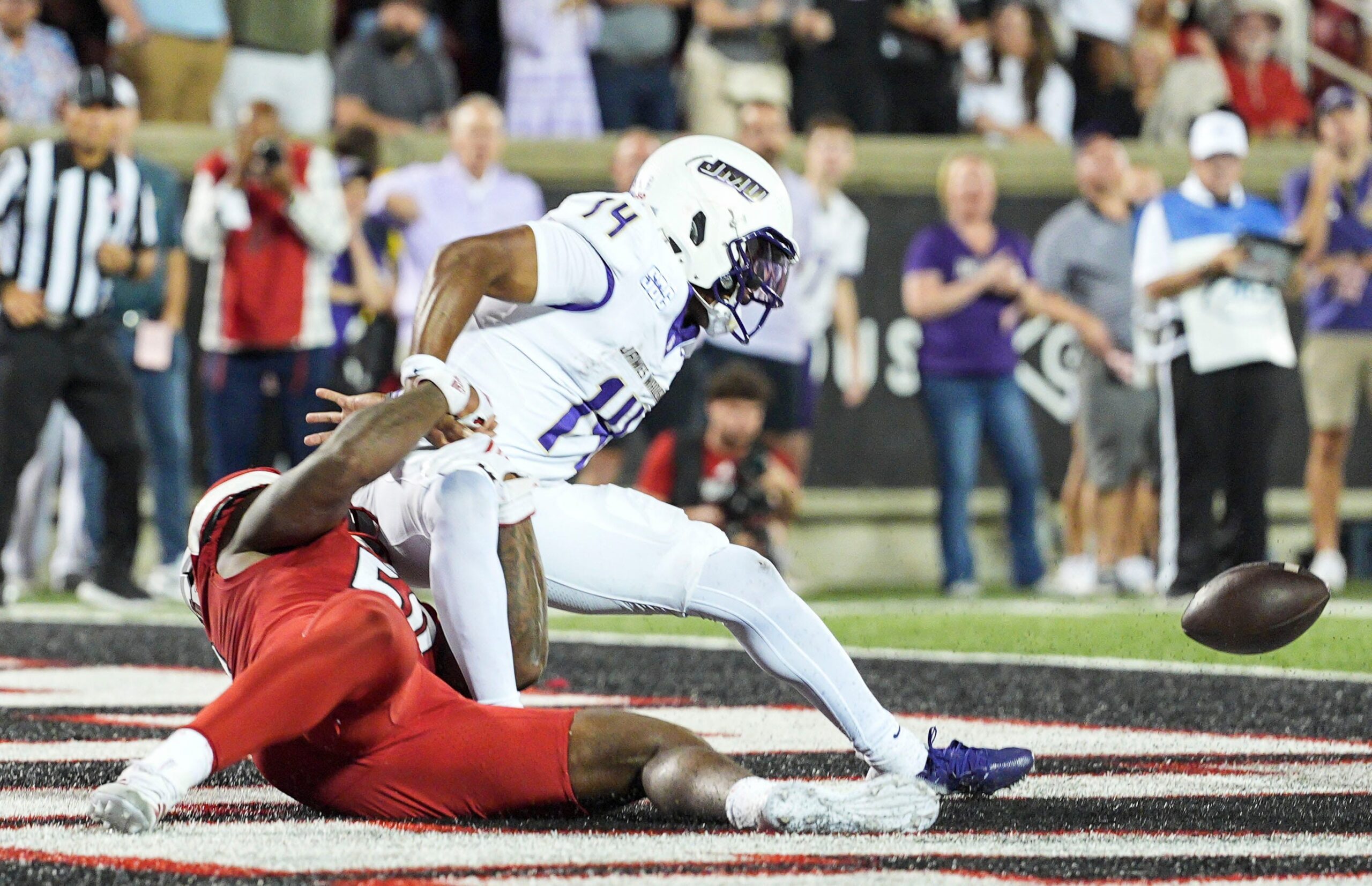 Louisville Cardinals defensive lineman Clev Lubin (50) strips the ball away from James Madison Dukes quarterback Alonza Barnett III (14) that set up a fumble and recovery touchdown by Louisville Cardinals defensive lineman AJ Green (17) at L&N Credit Union Stadium in Louisville, Kentucky. Sept. 5, 2025